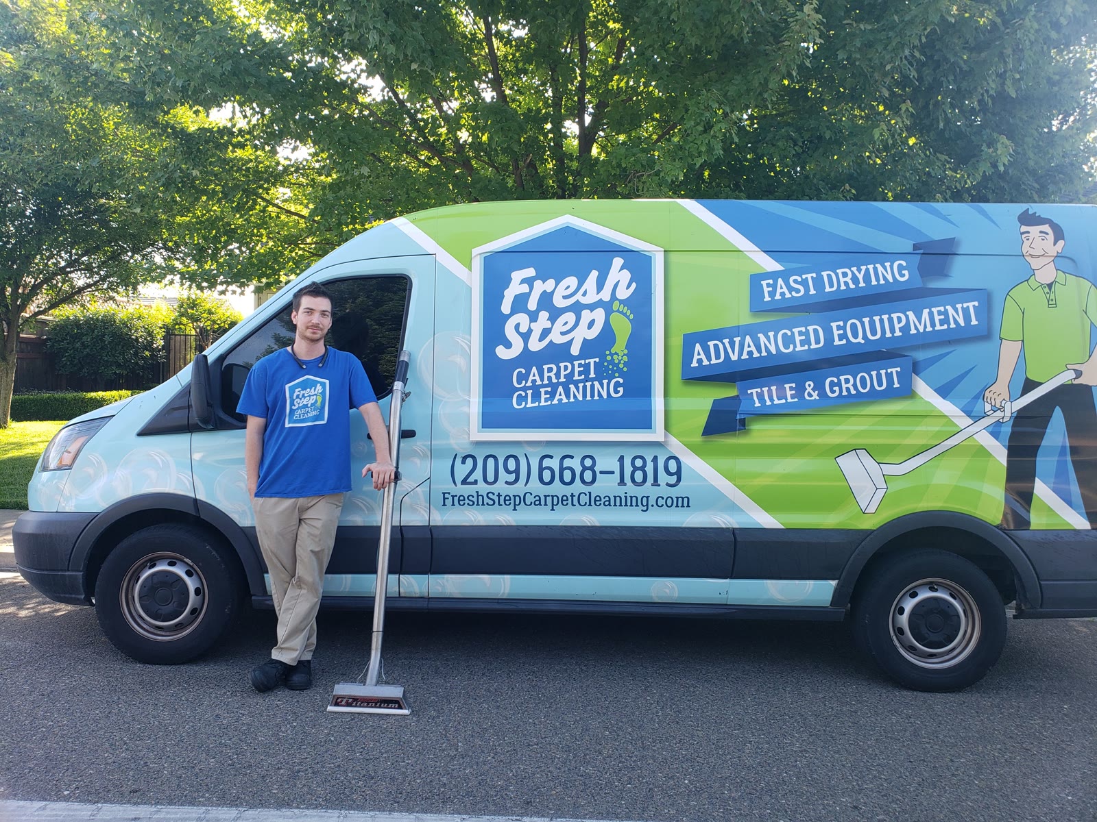 Fresh Step owner standing beside the company van