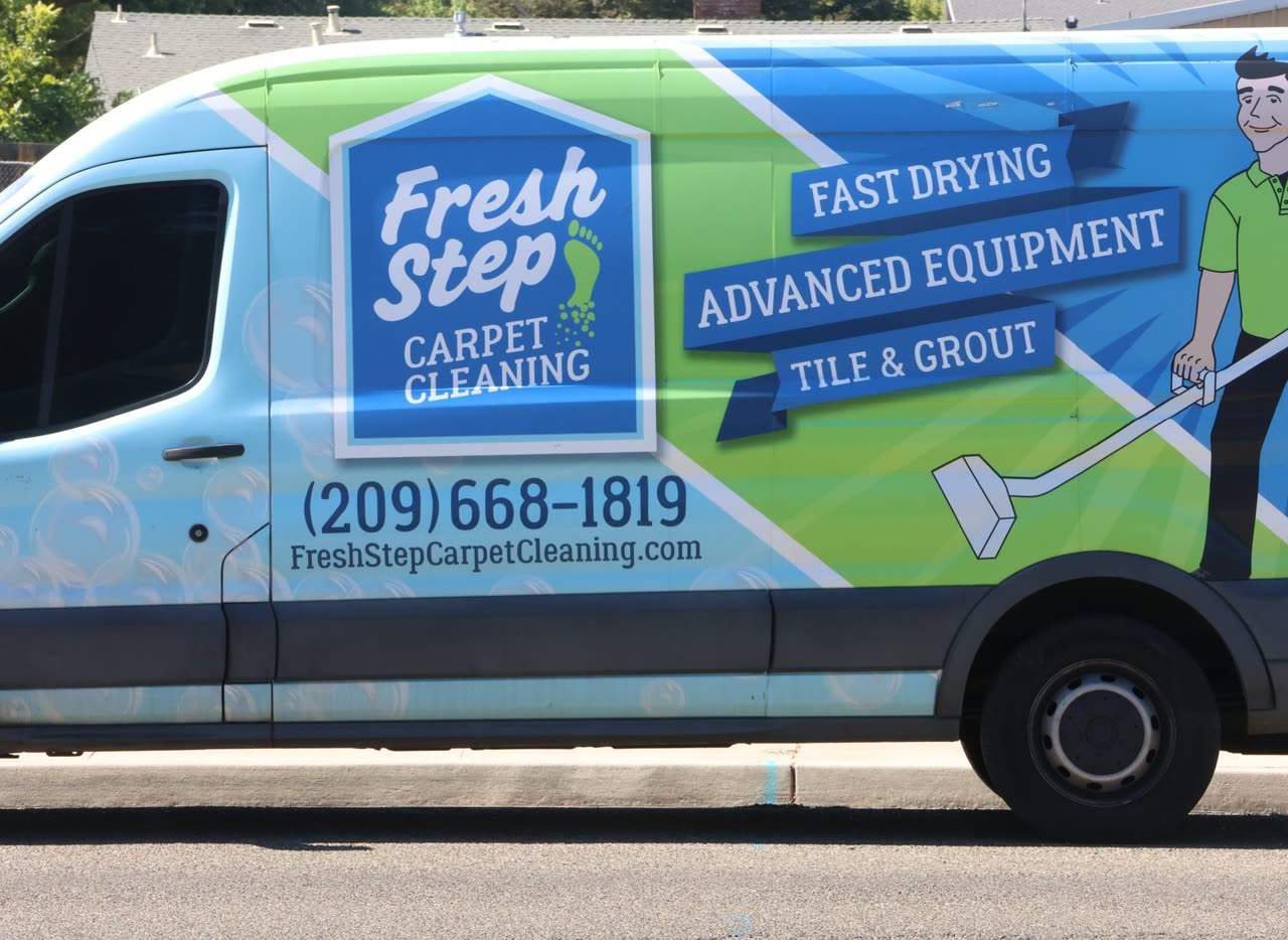 Fresh Step Carpet Cleaning van with the phone number on the door